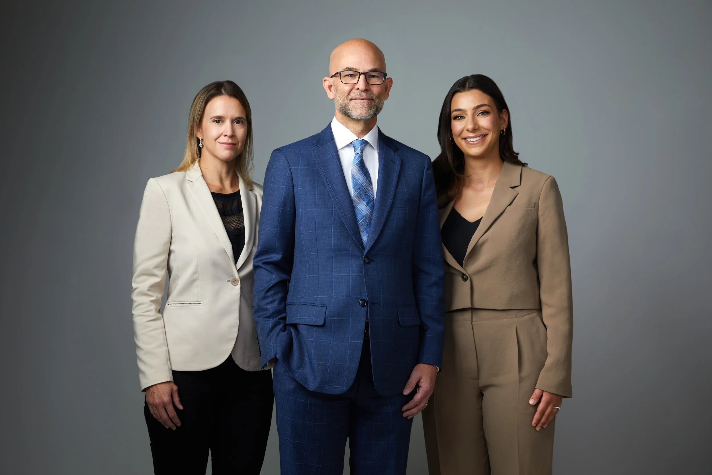 Group photo of a three-person team on charcoal, Edmonton studio