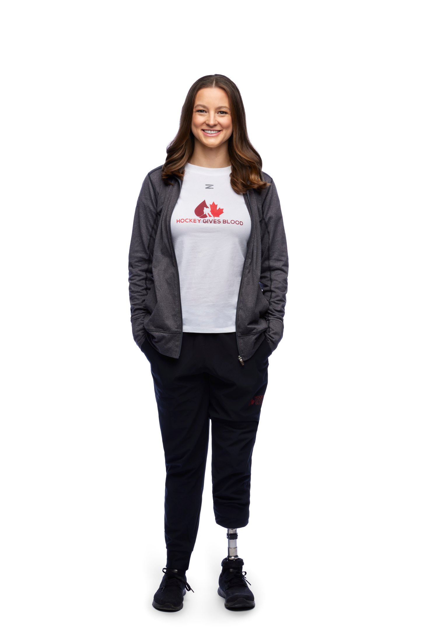 A woman standing on a running blade, hands in her pockets