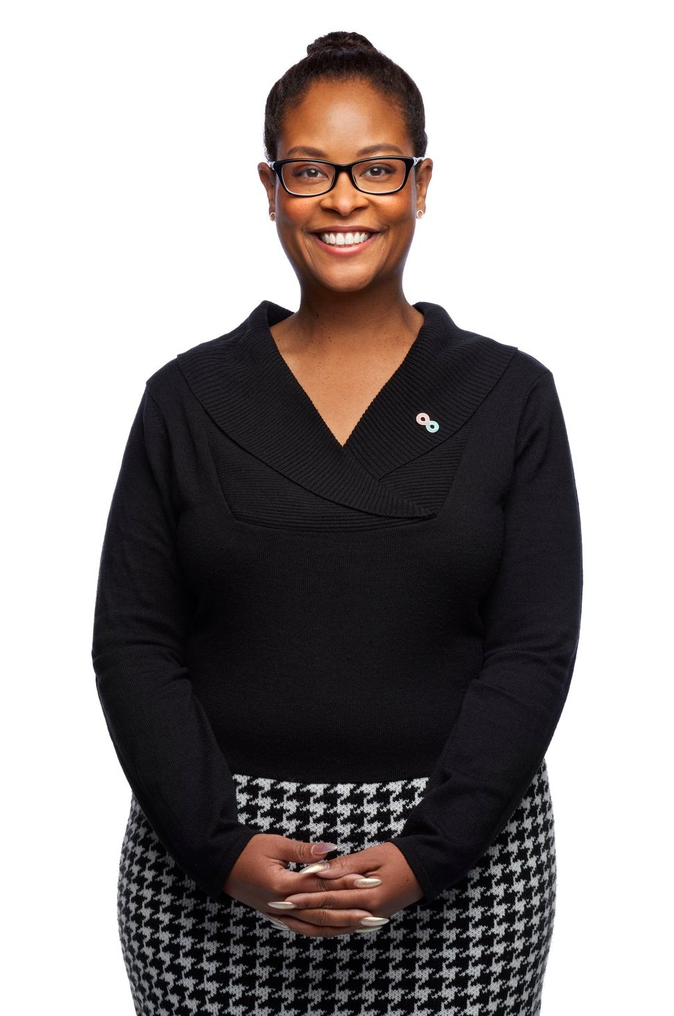 A woman in a dark quarter-zip against white