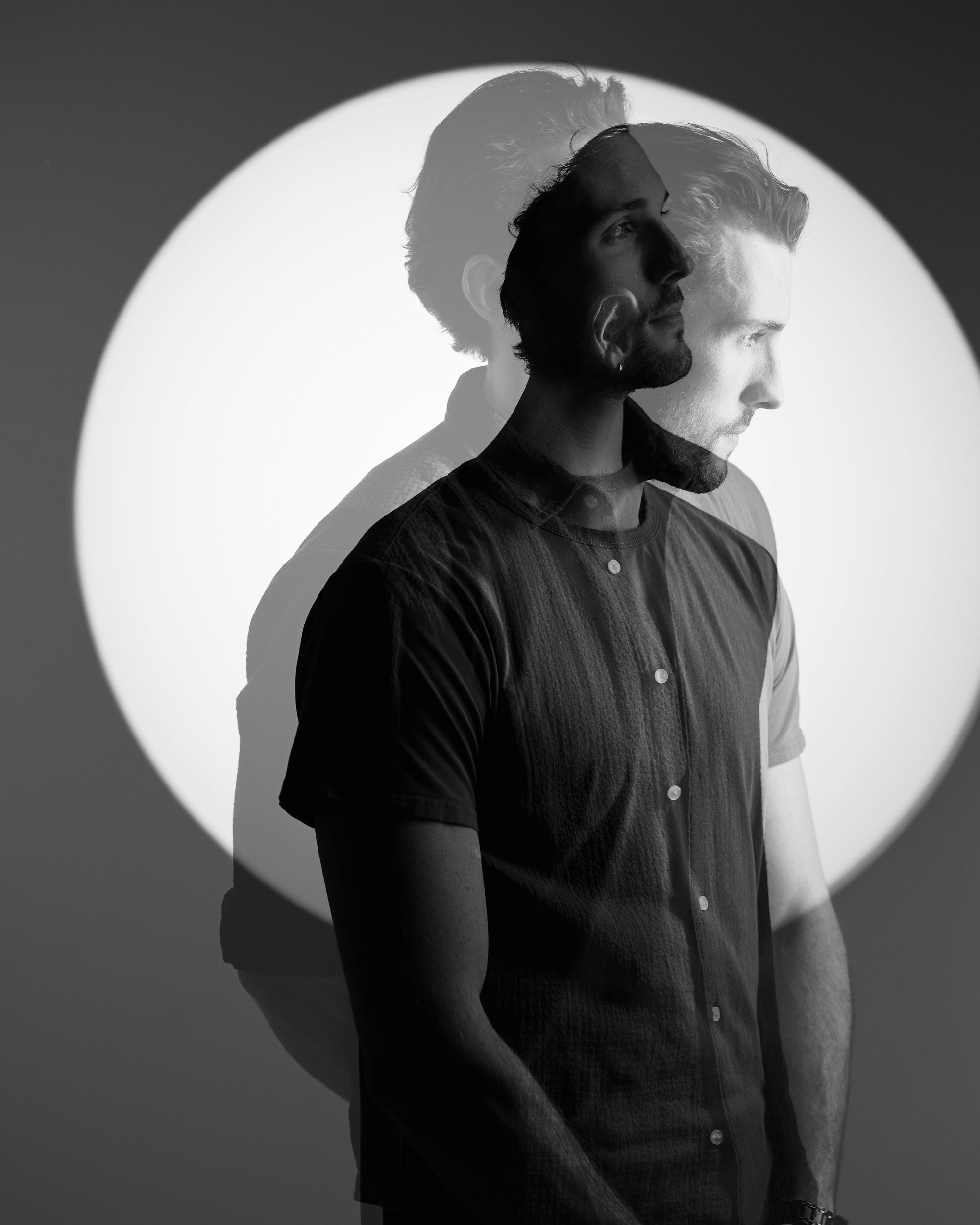 The same session, two exposures at once in a circle of light, black and white