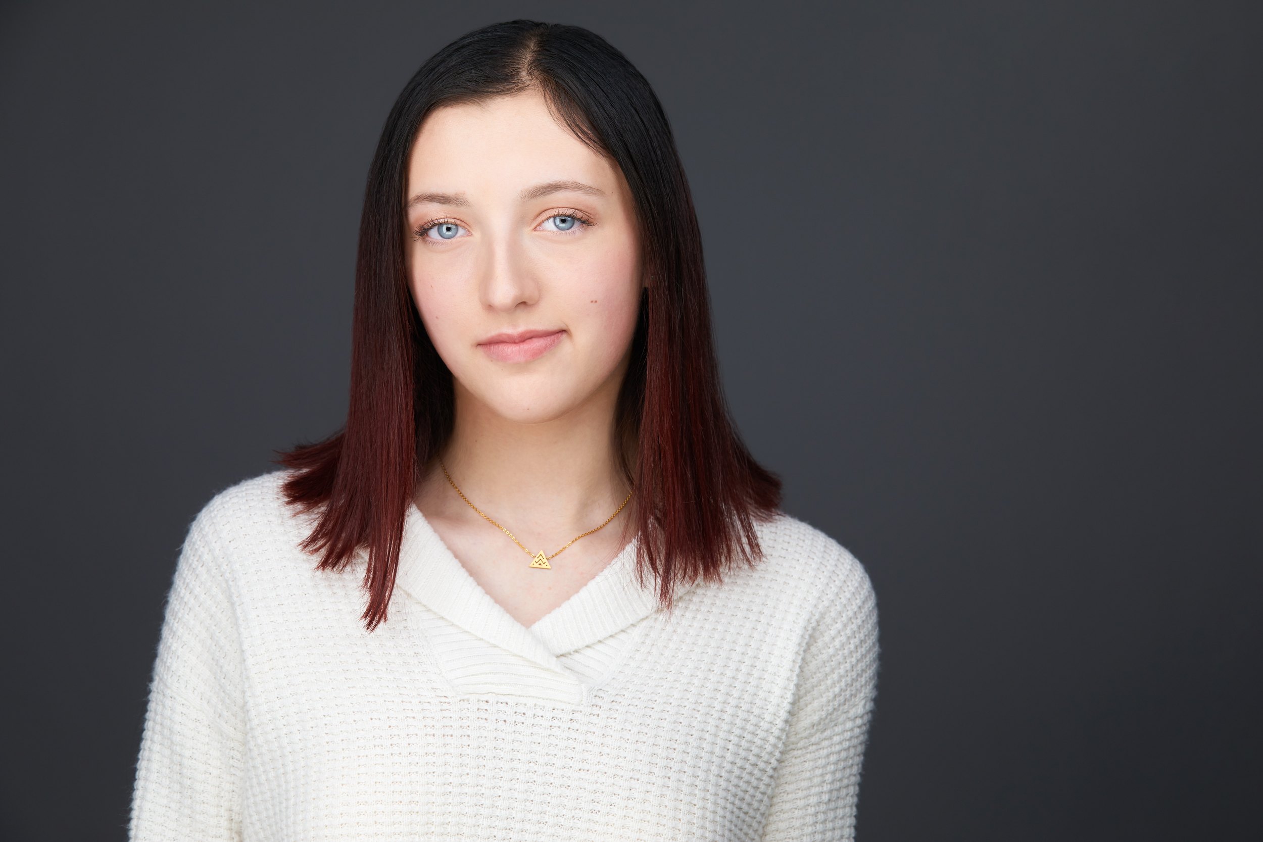 Dance headshot: a white sweater against grey