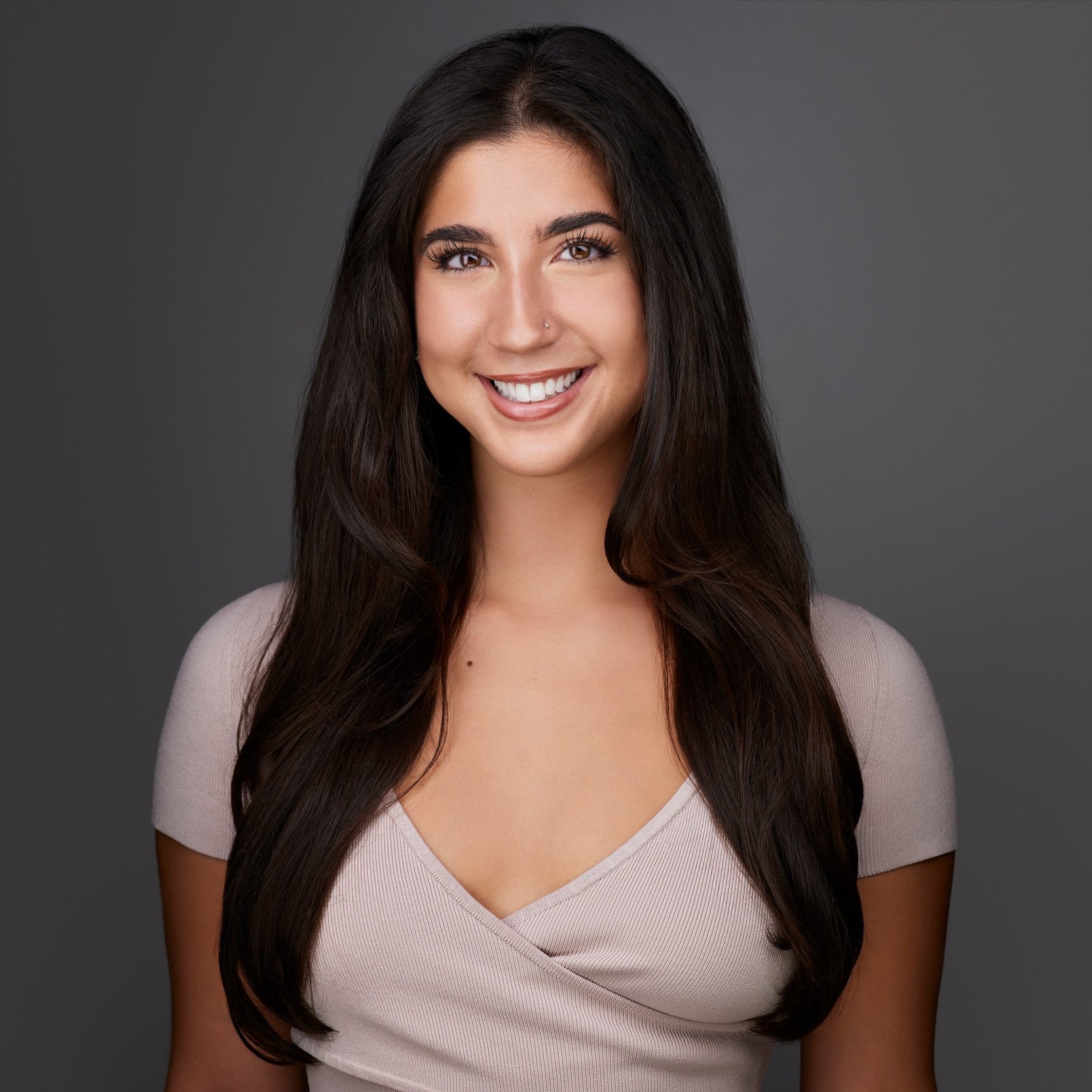 Dance headshot: a pink top against grey
