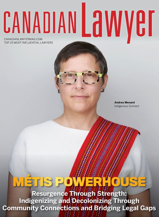 Canadian Lawyer cover, Métis Powerhouse: Andrea Menard in a white top and a red woven sash, against grey