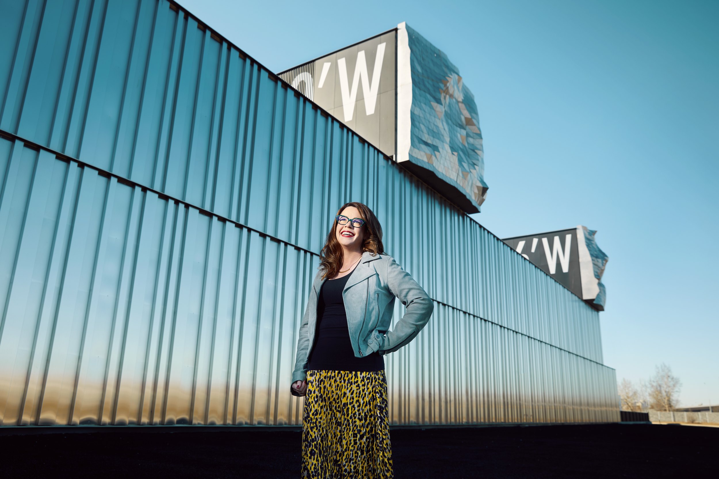 The frame the page ran: a woman against the blue corrugated wall, the sign above catching the last of the light