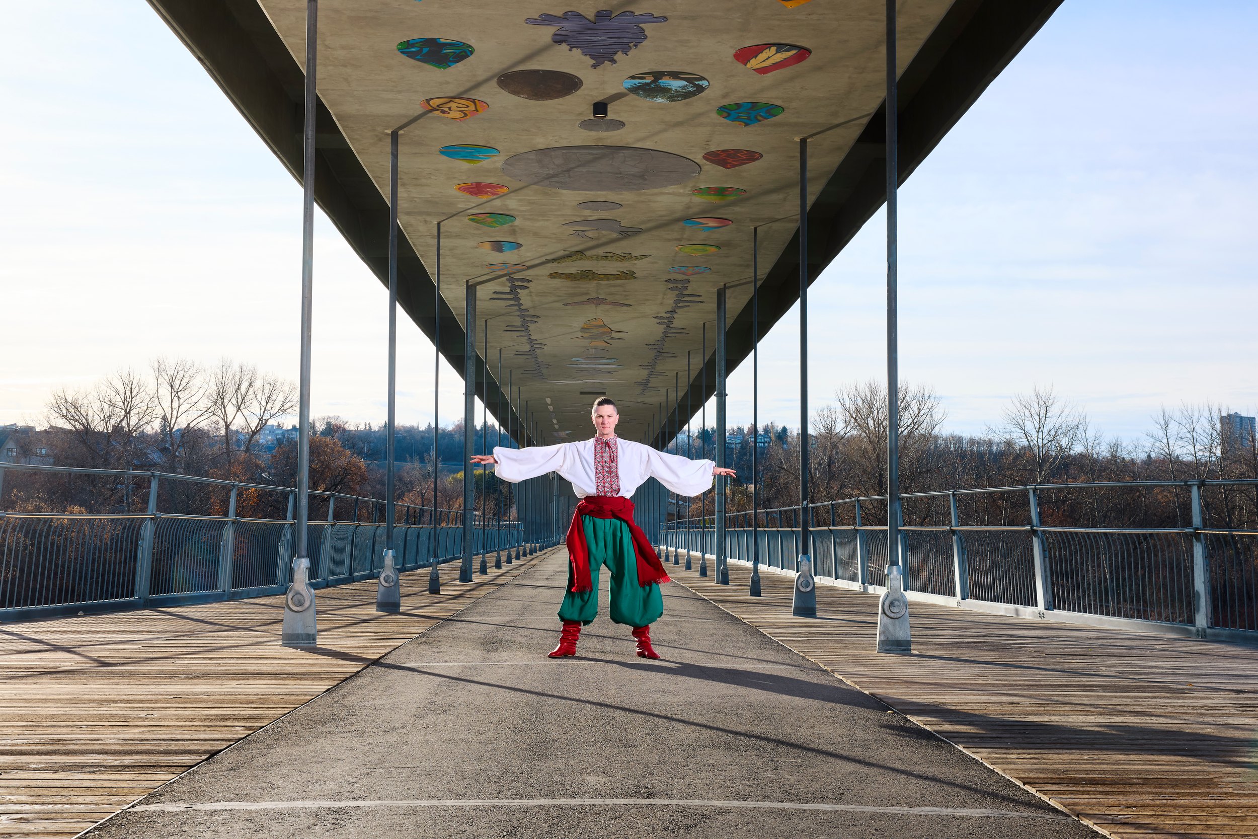 Wide along the bridge, the dancer small under the span