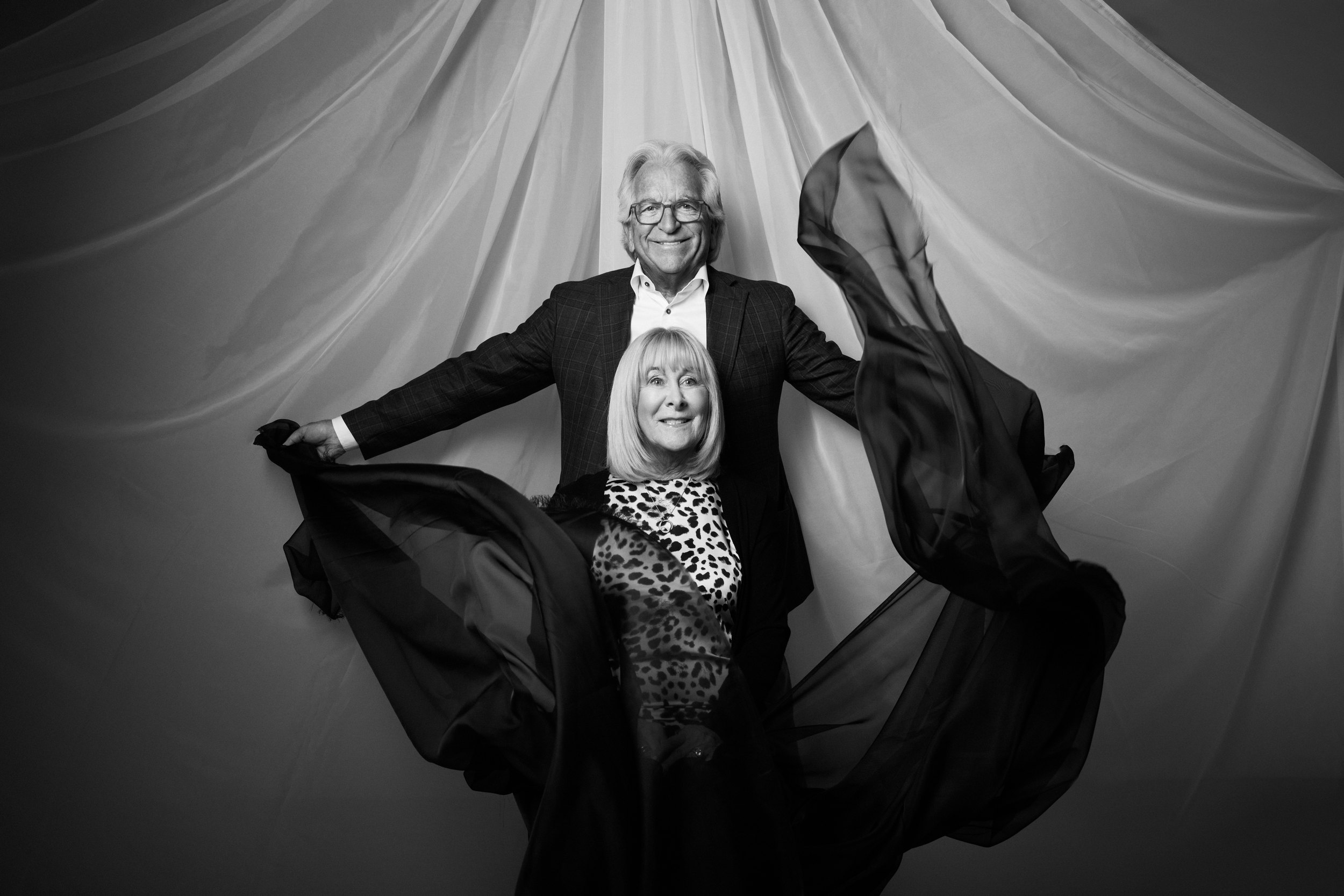 Two sitters together, the cloth spread between and above them