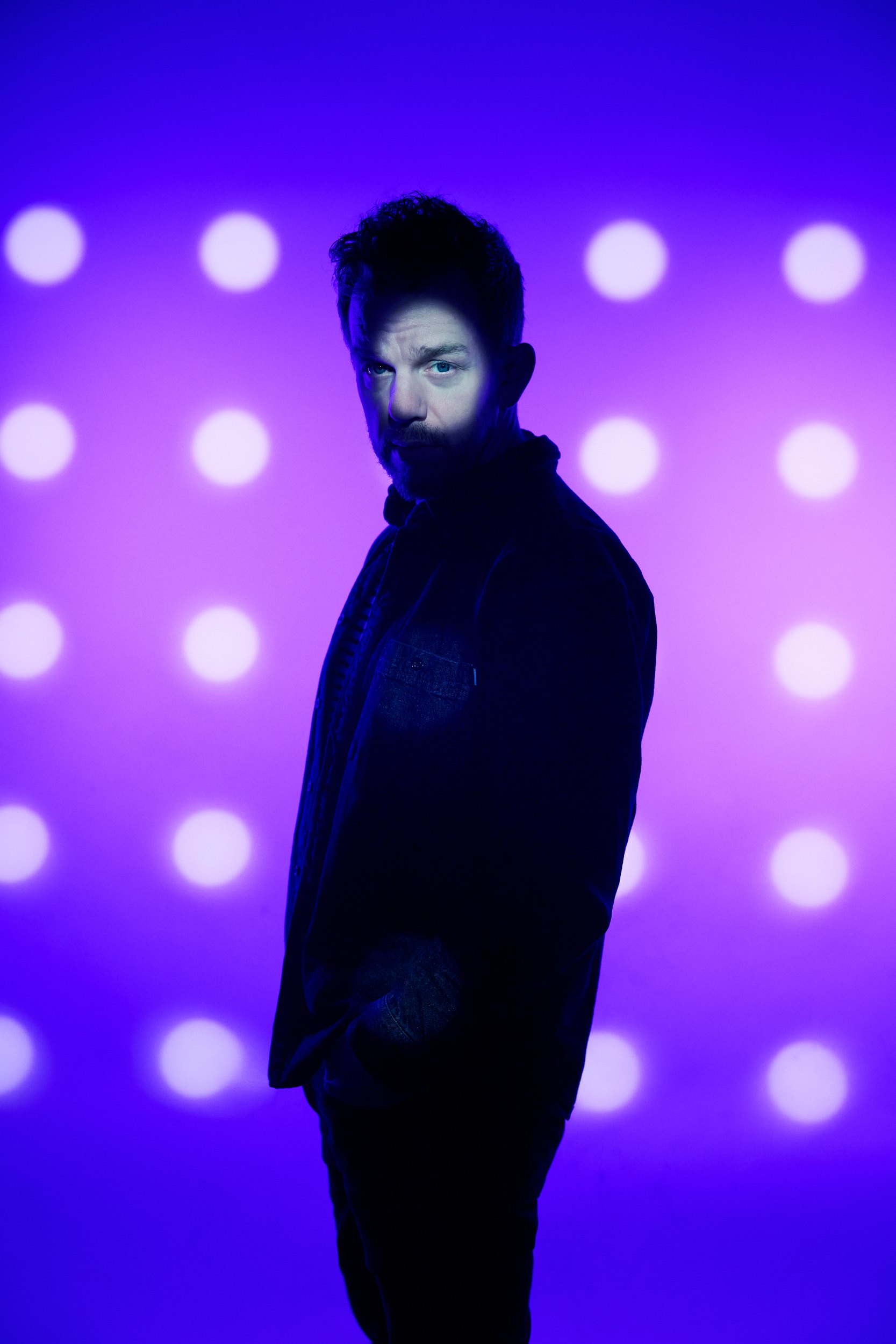 Another of the innovators, in a dark coat against white dots on violet