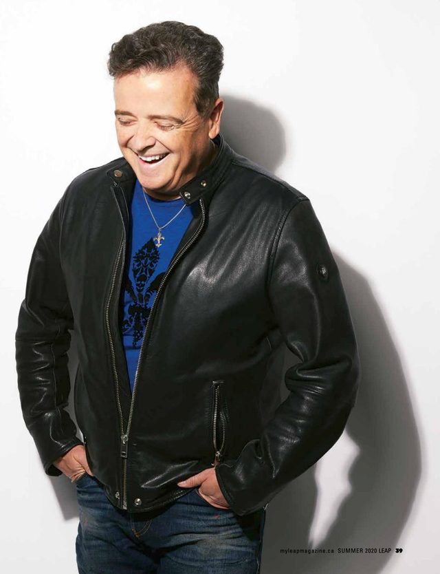 The facing page: Dr. Luc Berthiaume laughing in a black leather jacket against a white wall