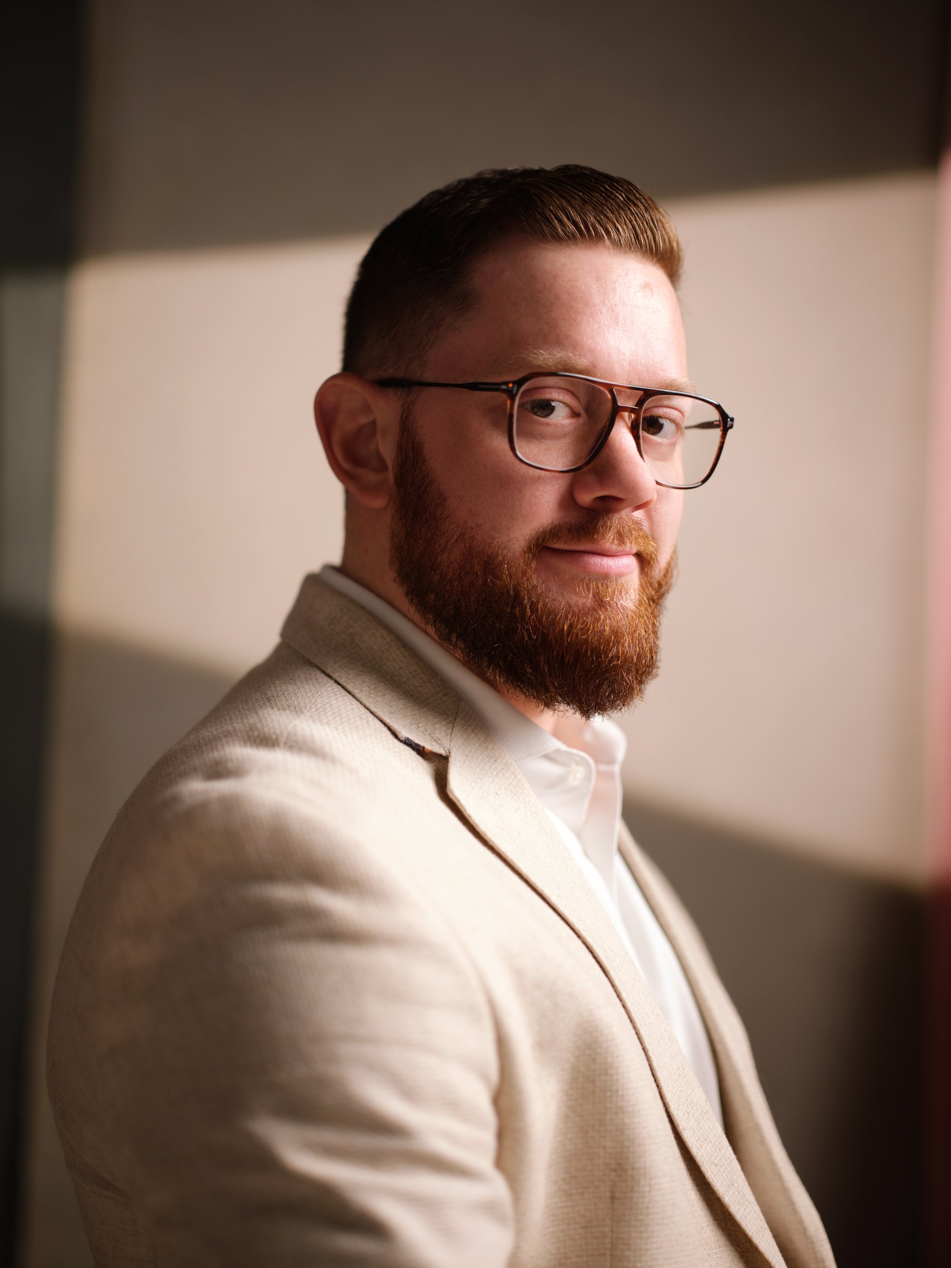 Leadership portrait: a cream jacket in window light