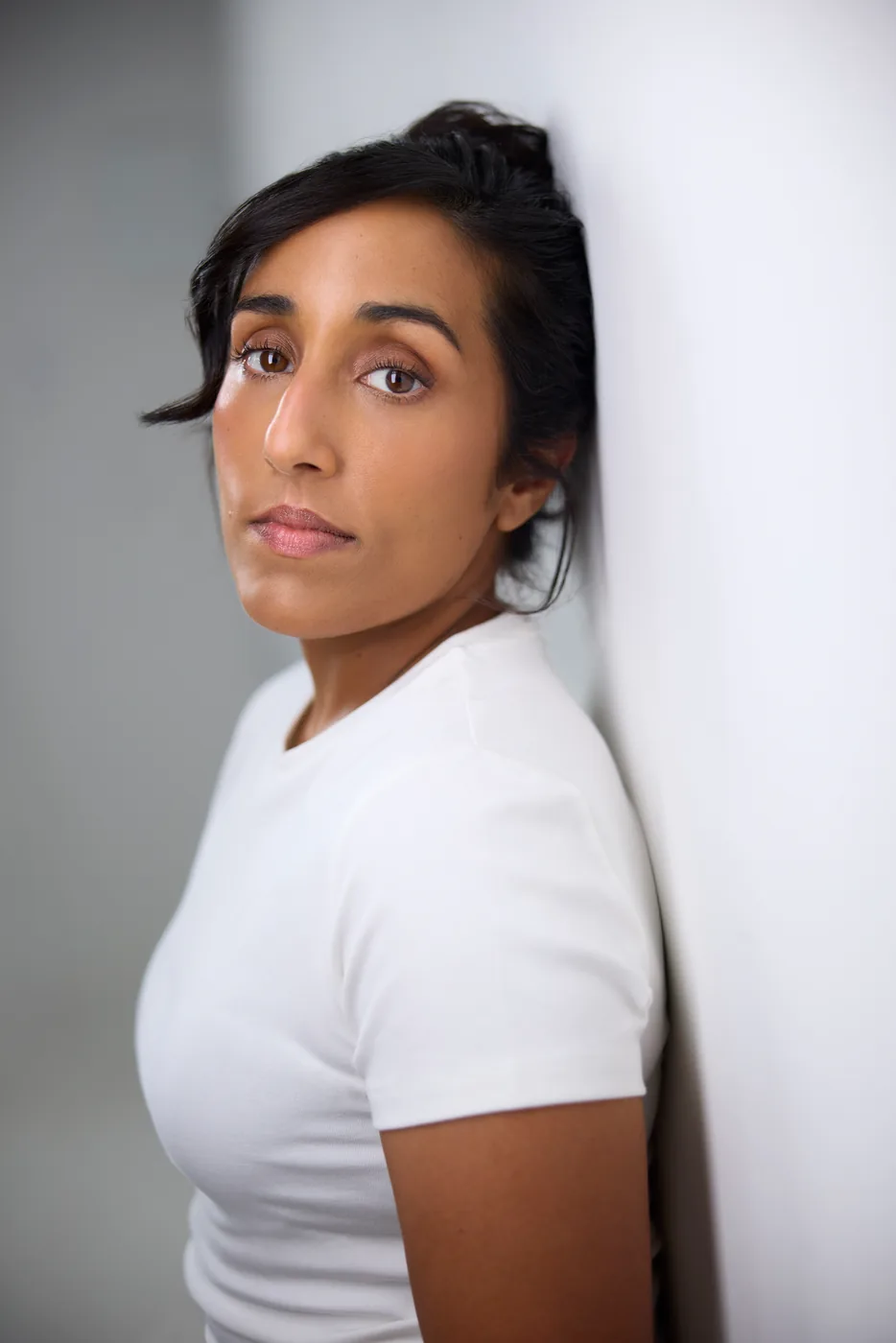 Ashley John against a white wall, actor headshot, Edmonton