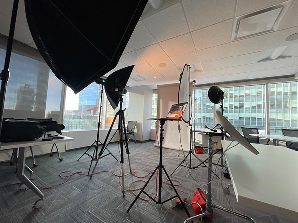 Strobe lighting setup in an office with large windows