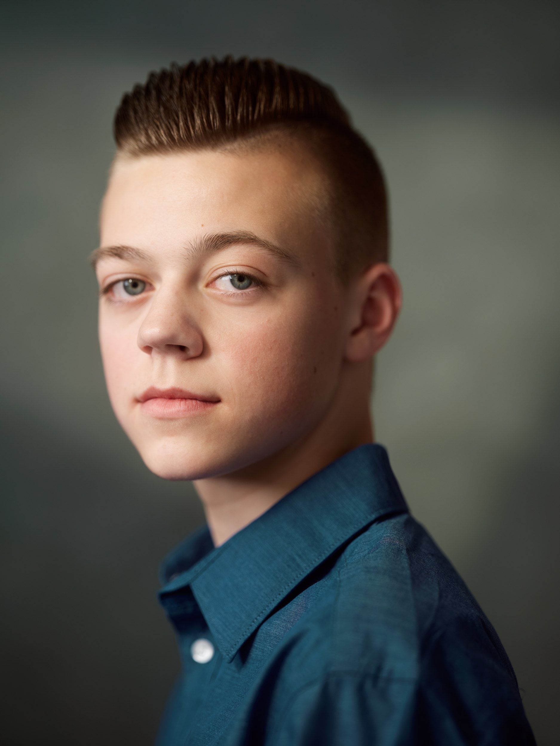 Kids and teens headshot: a blue shirt against grey