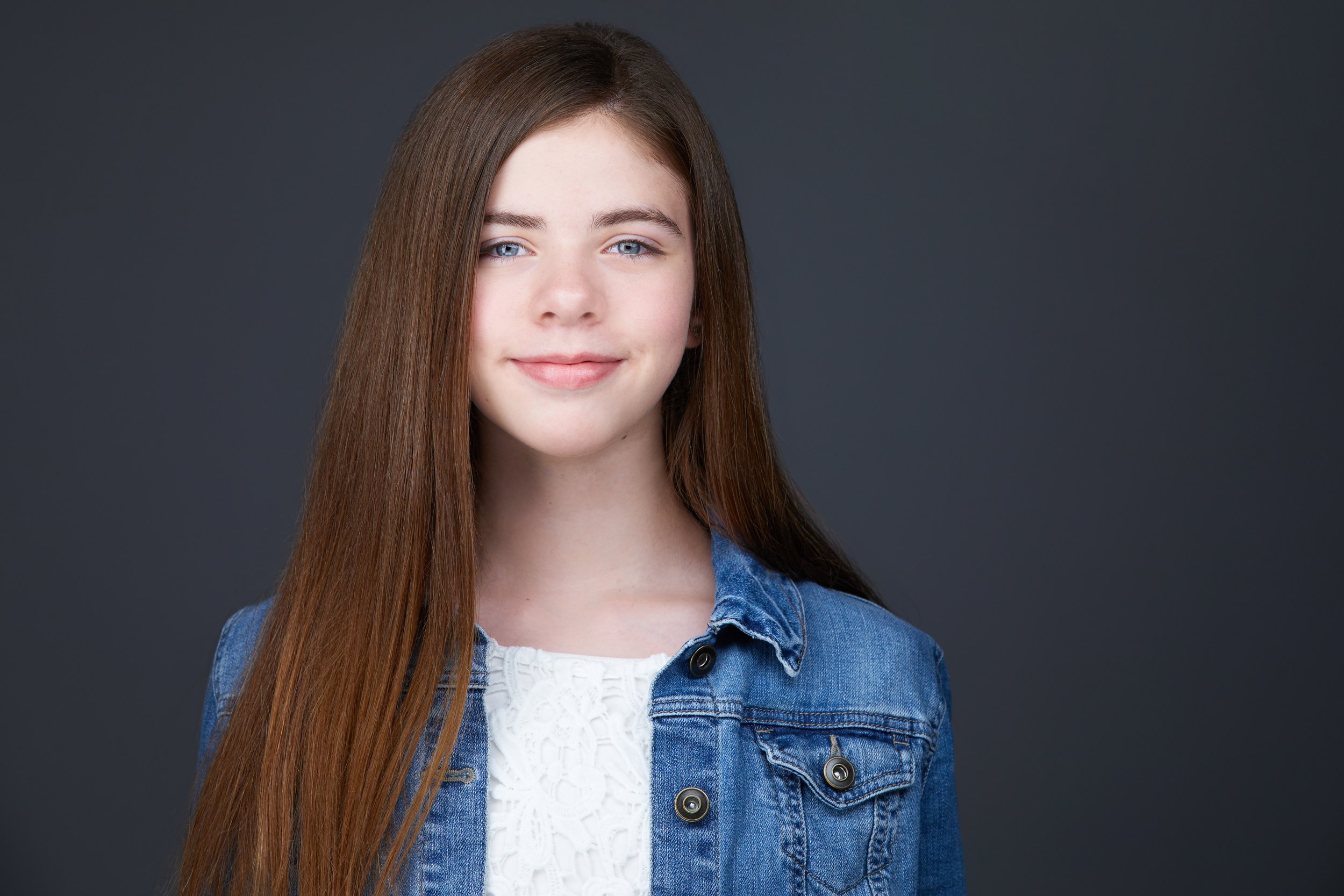 Kids and teens headshot: a denim jacket over white against charcoal