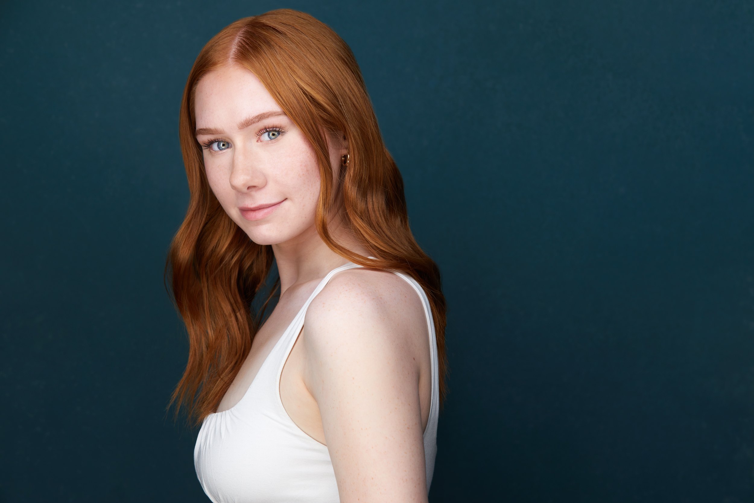 Kids and teens headshot: a white cami against teal, red hair