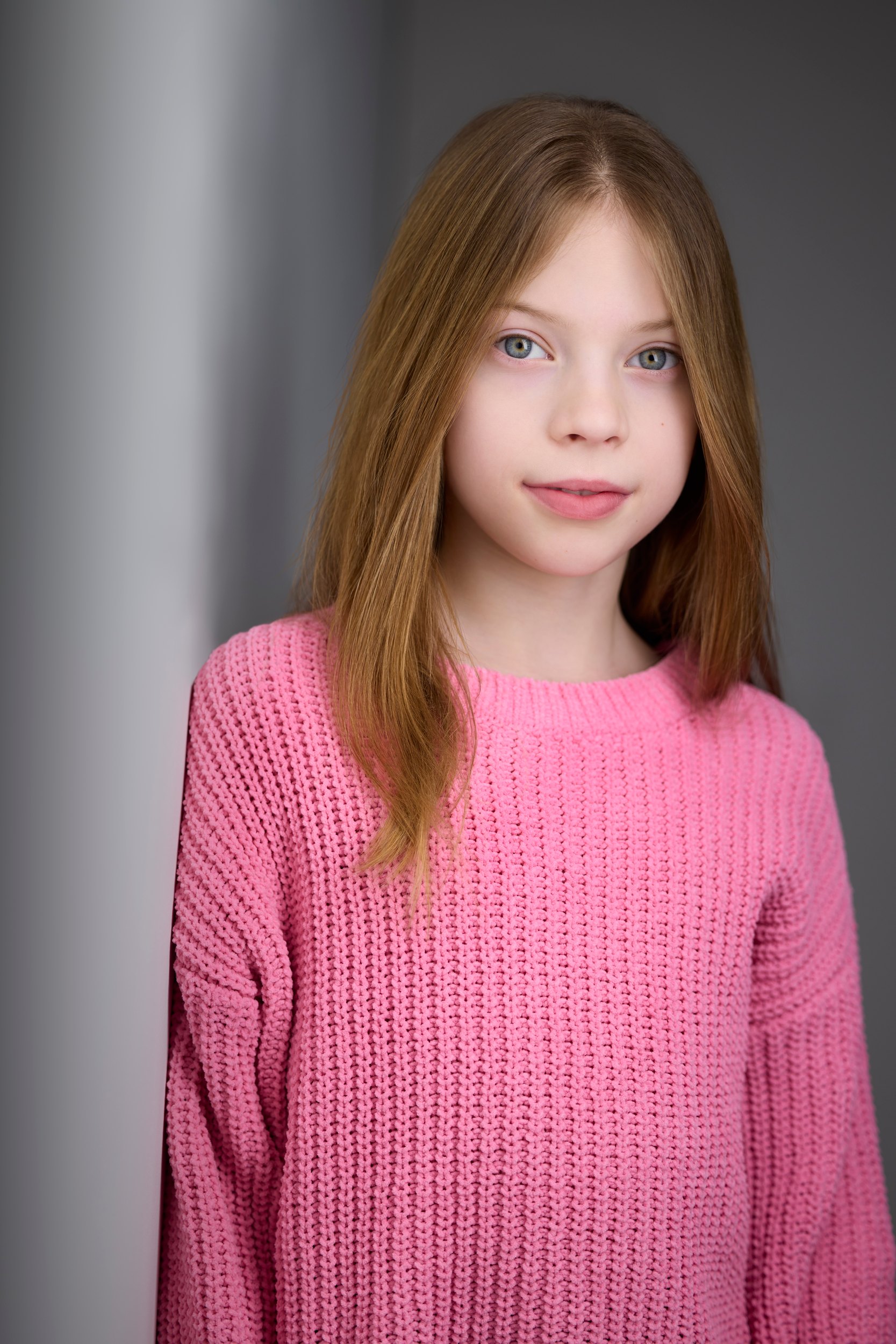 The same session, a pink knit sweater