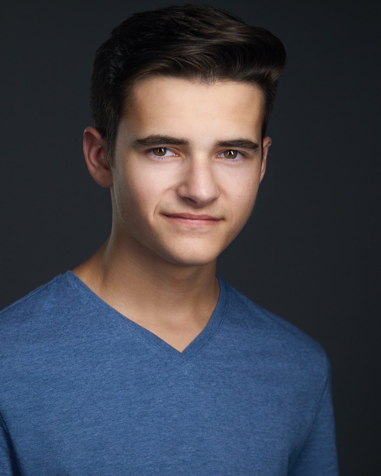 Kids and teens headshot: a blue V-neck against charcoal