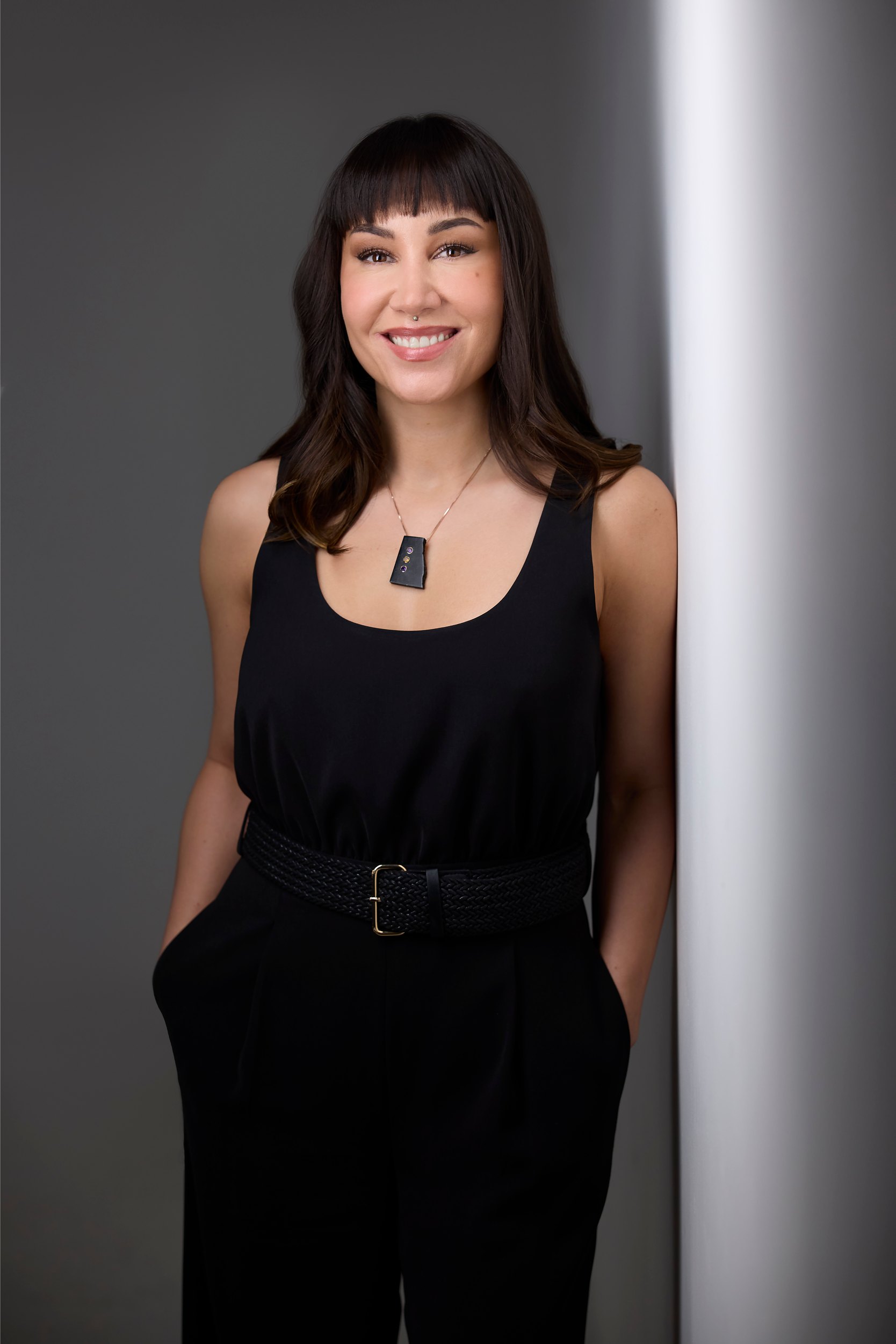 Personal branding portrait: a black top against a wall of light