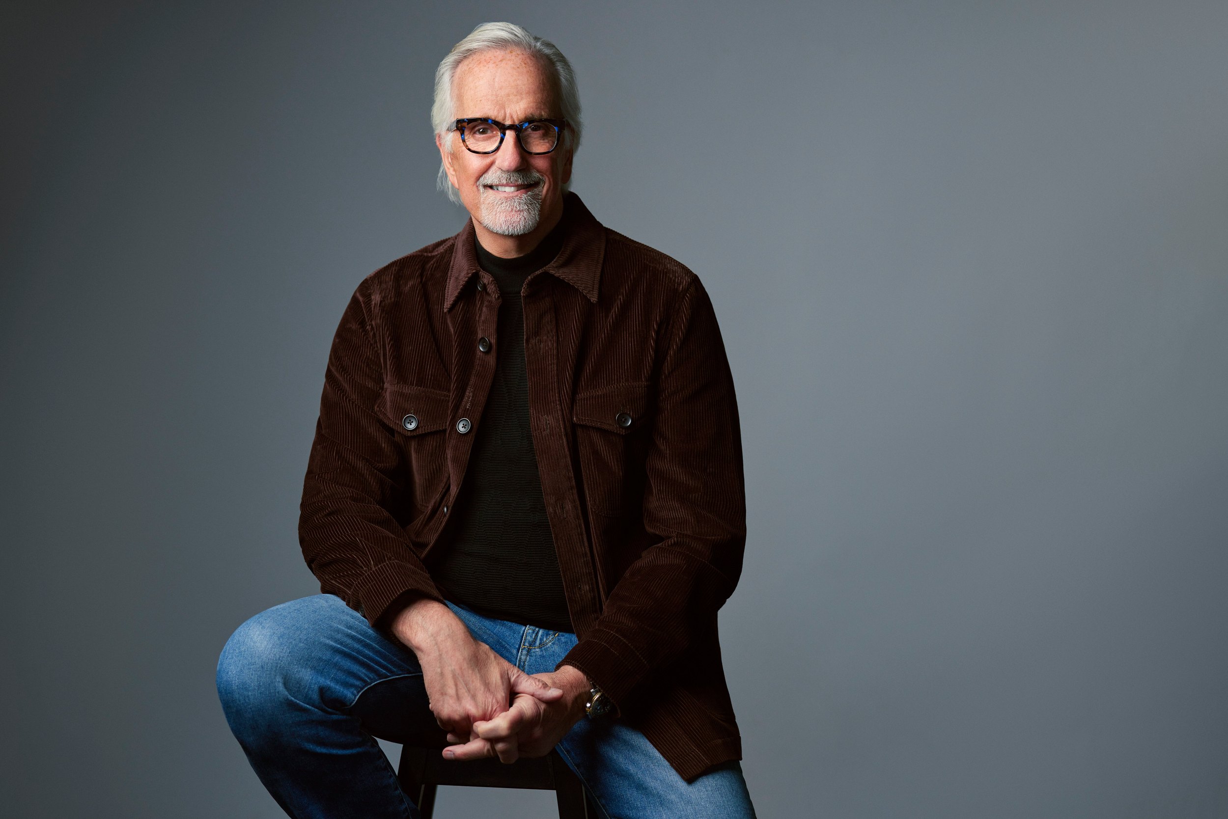 Personal branding portrait, brown jacket, seated