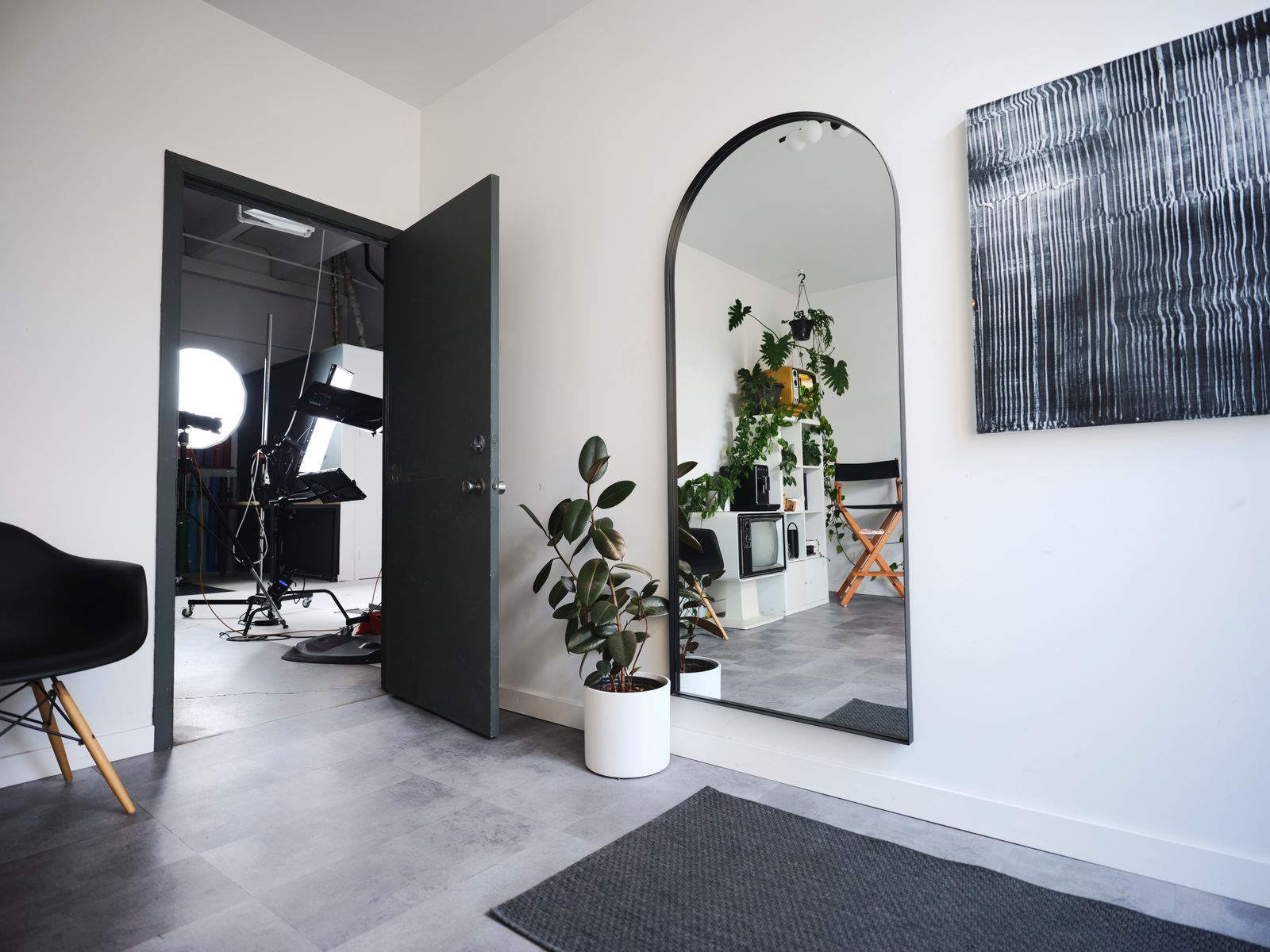 The studio lounge — director’s chair, shelves and plants